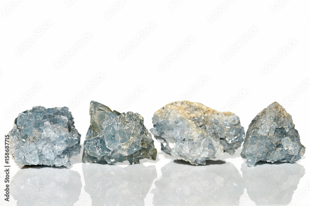 Set of four Celestine crystals on white background with reflection Set of four Celestine crystals on white background with reflection