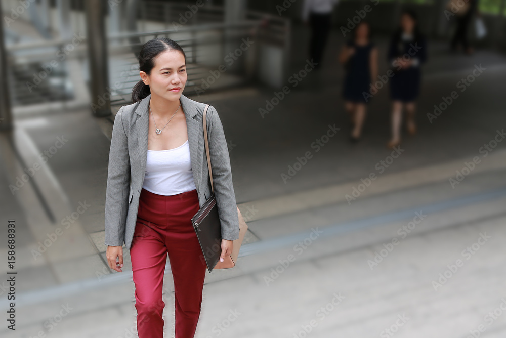Beautiful young business woman walking outside. Asian businesswoman office worker in downtown business district. Beautiful young business woman walking outside. Asian businesswoman office worker in downtown business district.