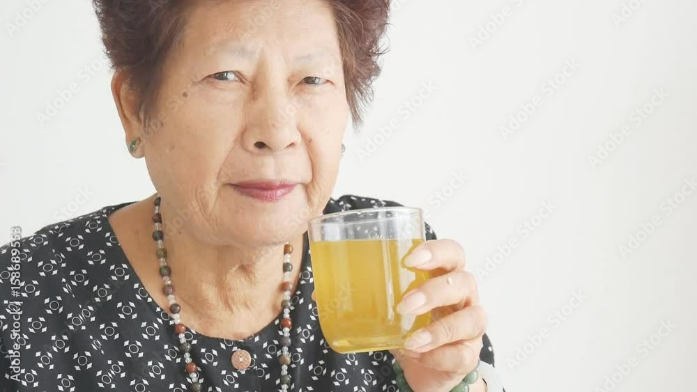 Asian senior lady drinking lemon juice, health care lifestyle Asian senior lady drinking lemon juice, health care lifestyle