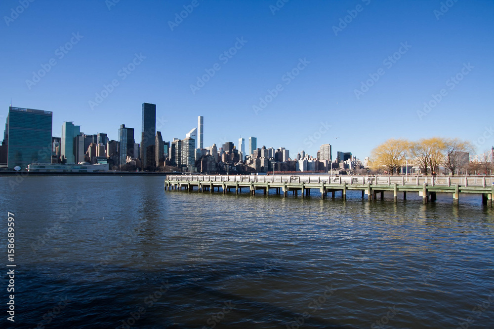 Pier on East river and buildings in Manhattan