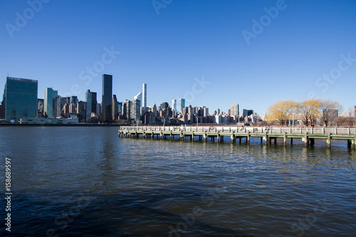 Pier on East river and buildings in Manhattan
