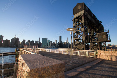 Transfer bridges, support gantries, and piers at Gantry Plaza State Park And buildings in Manhattan before sunset