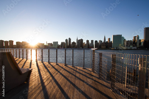 Photography Wooden walkway and fence at Gantry Plaza State Park next to East river and Manha