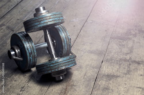 Vintage dumbbells on the wooden floor