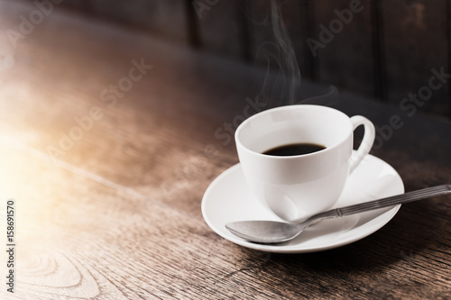 Espresso Coffee or Americano black Coffee in White cup on wood table with copy space.