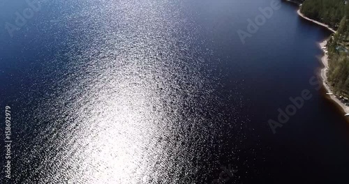 Pielinen, Cinema 4k aerial tilt view of a flight on the coast of loma-koli and revealing pielinen lake, at a sunny spring day, in Koli, Karjala, Finland photo