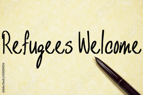 refugees welcome text write on paper