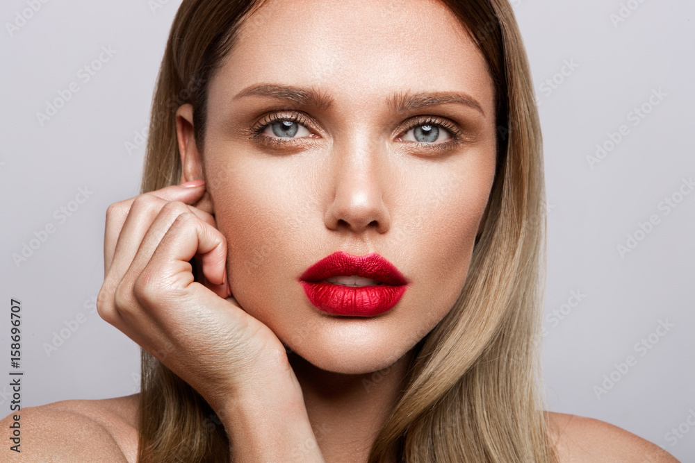 Beautiful young model with red lips and nude manicure Beautiful young model with red lips and nude manicure