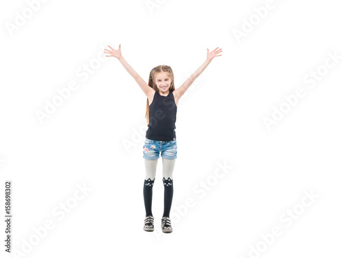 teen girl raising hands and smiling widely
