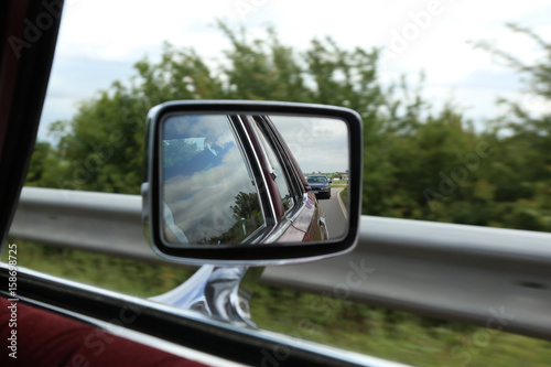 Road in car mirror © leomalsam