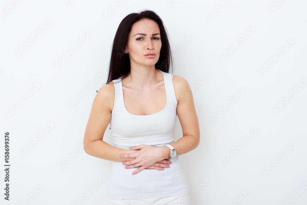 Woman with pain is holding her aching belly Woman with pain is holding her aching belly