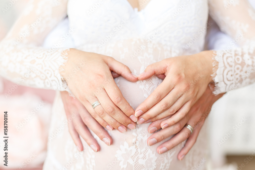 Waiting of baby-girl, mammy`s belly in lace dress closeup Waiting of baby-girl, mammy`s belly in lace dress closeup