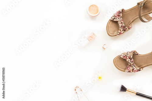 Composition with fashion woman shoes, feminine gold accessories, cosmetics on white background. Top view. flat lay, copy space