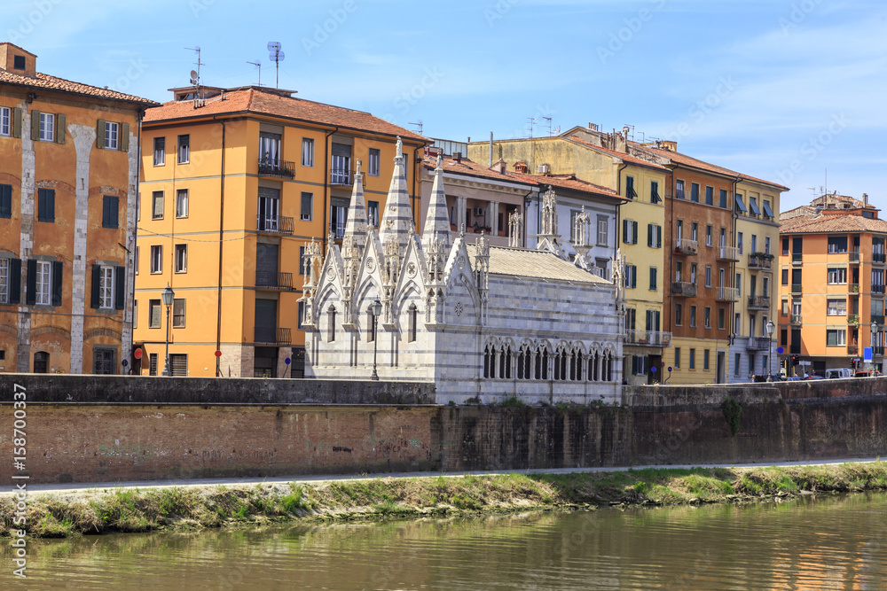 Pisa - historic townhouses along the Arno embankment. Small Gothic church of Santa Maria della Spina from 1230