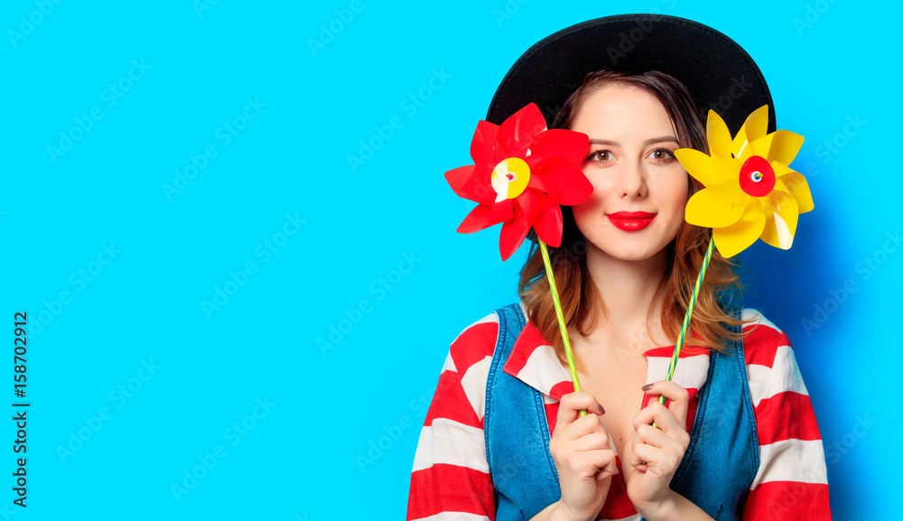 smiling woman with two pinwheels smiling woman with two pinwheels