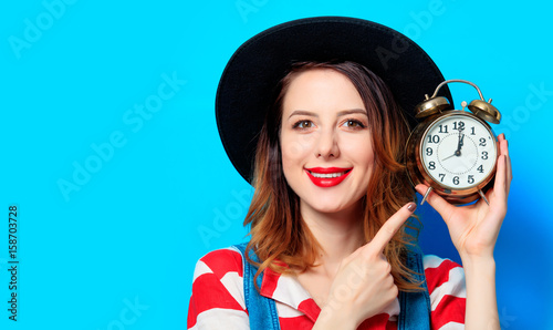 Woman with retro alarm clock