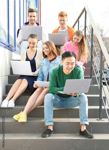Young people with gadgets s...