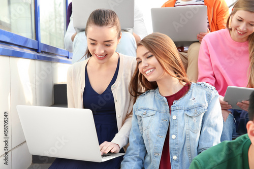 Young people with gadgets s...