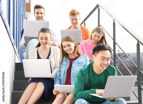 Young people with gadgets s...