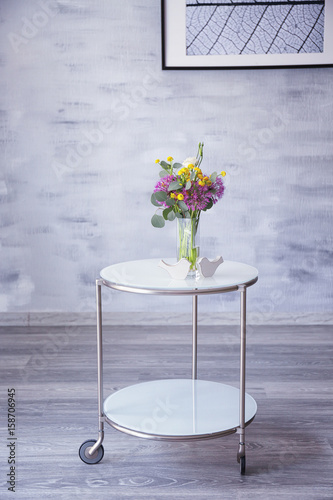 Beautiful flower bouquet on coffee table in room