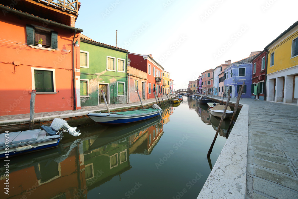 Boats moored on the waterway and reflection on the water of the