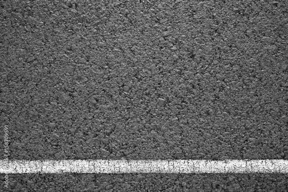 Fototapeta premium Asphalt background texture with some fine grain with road line on white
