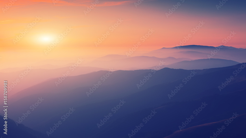 Silhouettes of the mountain hills at sunset