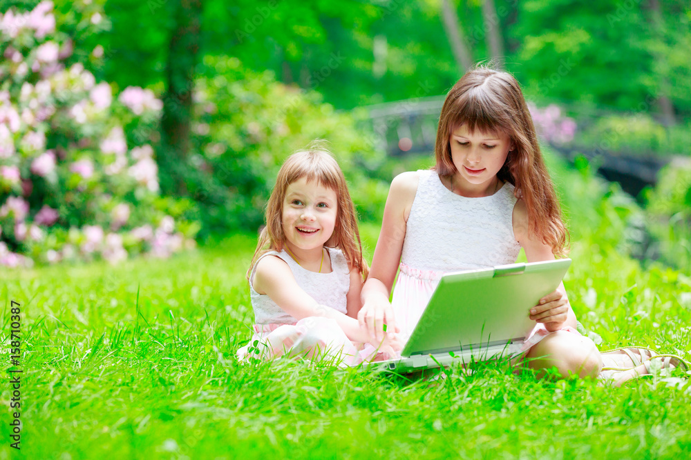 Two sisters have a fun with laptop Two sisters have a fun with laptop