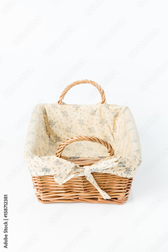 Close up of wicker basket. Isolated on a white background.