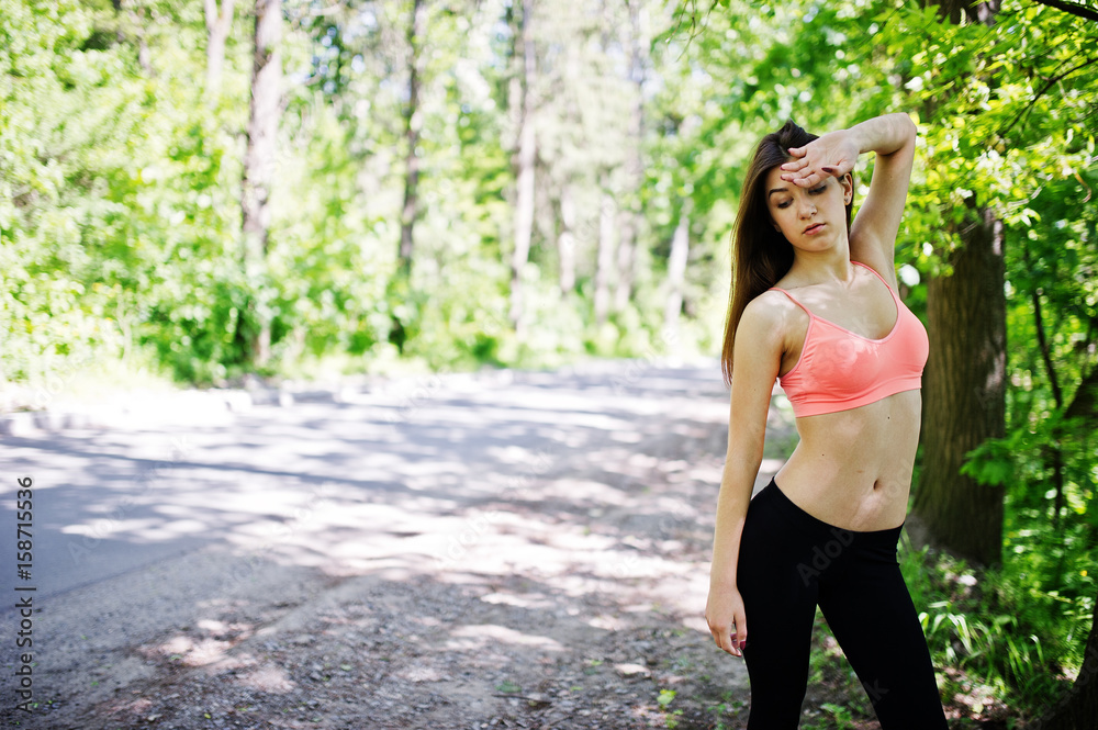 Fitness sport girl in sportswear resting in forest, outdoor sports, urban style. Fitness sport girl in sportswear resting in forest, outdoor sports, urban style.