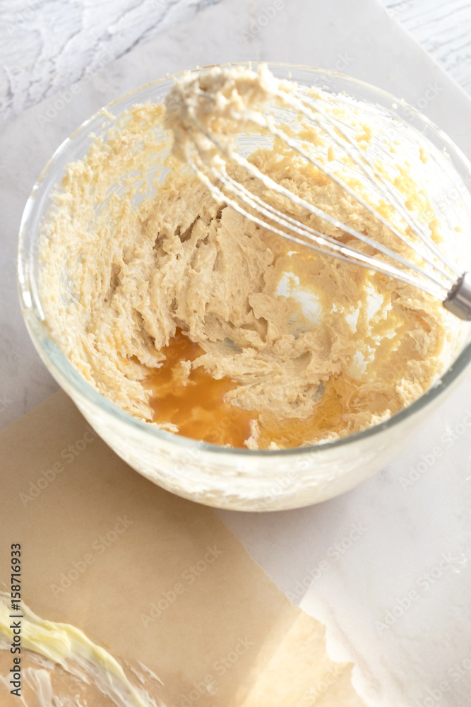 MIxing baking ingredients in a bowl for cake or pancakes. Light food photography concept MIxing baking ingredients in a bowl for cake or pancakes. Light food photography concept
