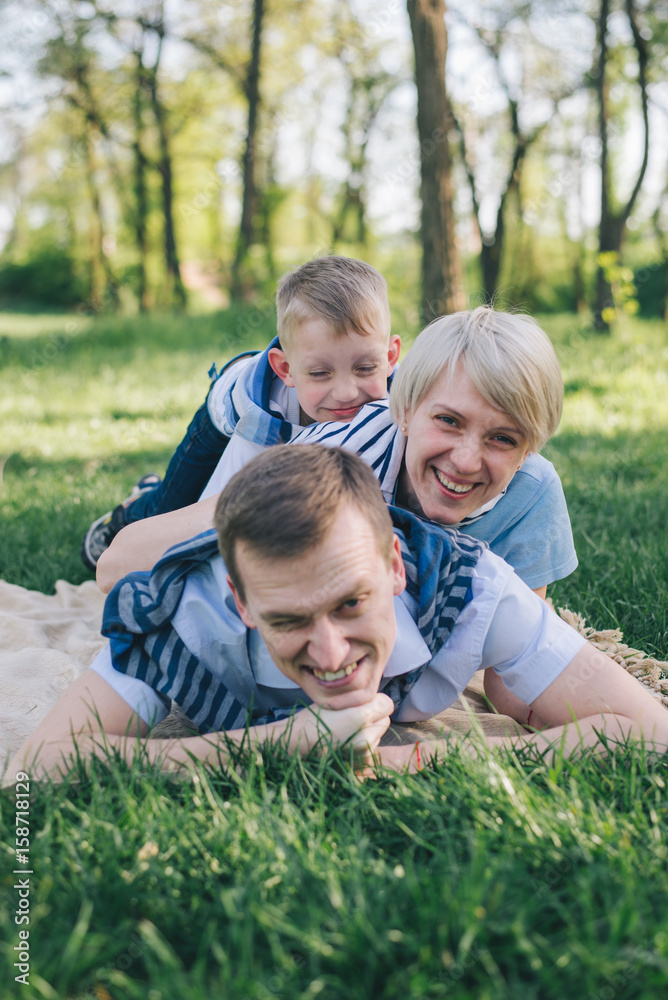 Fototapeta premium father mother and son lie on each other