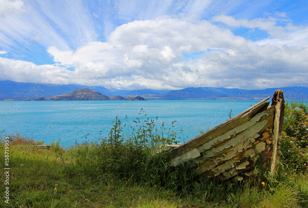 Boat on shore of General Carrera Lake with islands, Patagonia, Chile