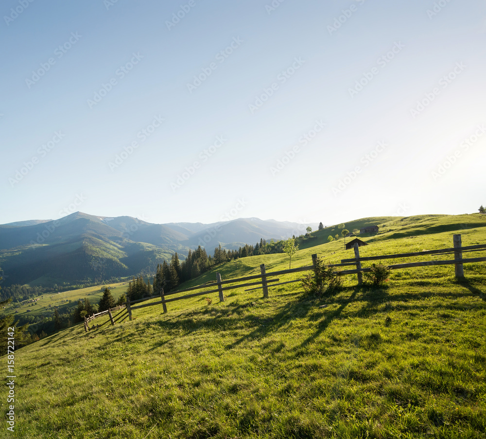 Fence on the mountain hills. Beautiful natural landscape in the summer time