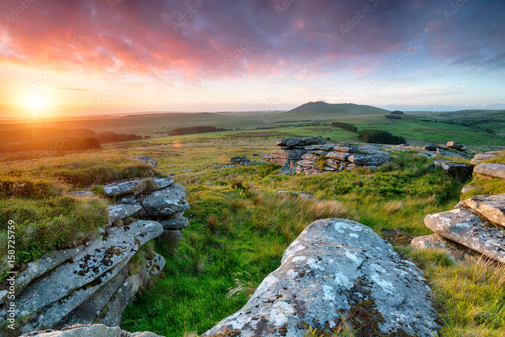 Stunning sunset from the top of Garrow Tor  on Bodmin Moor in Cornwall with Roughtor in the distance