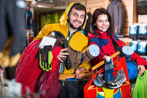 Young happy demonstrating new tourist equipment