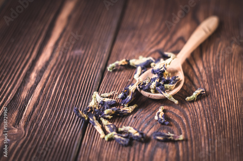 flower tea in wooden spoons and white cup