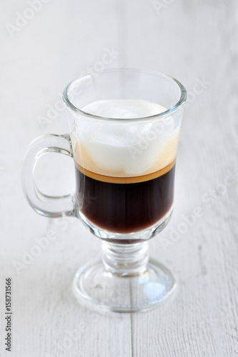 Coffee in a glass on a wooden table