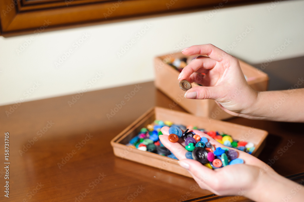 colorful sewing buttons in the hands colorful sewing buttons in the hands