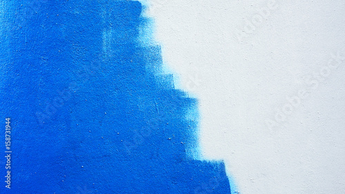 Unfinished blue painted wall background photo