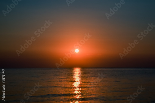 Beautiful sunset. The sun sets over the sea. © Лилия Ильина