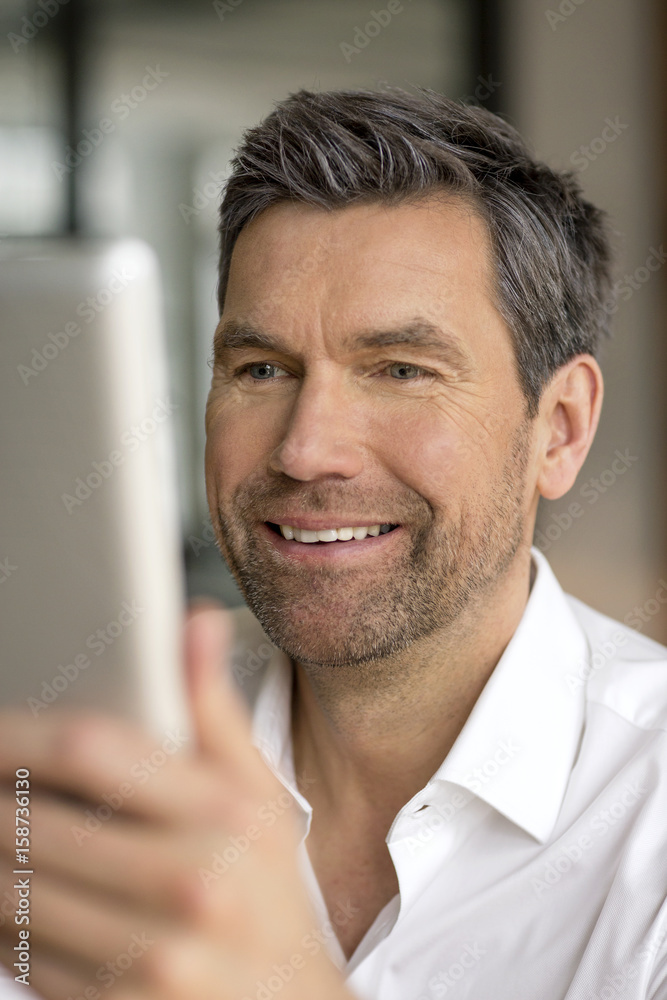 Smiling businessman using tablet Smiling businessman using tablet