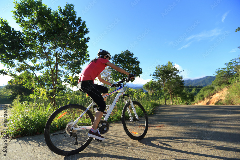 riding mountain bike on sunrise forest trail