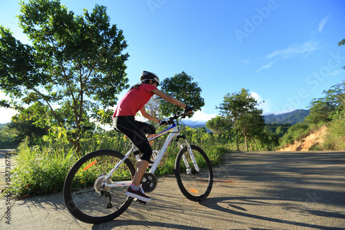 riding mountain bike on sunrise forest trail © lzf