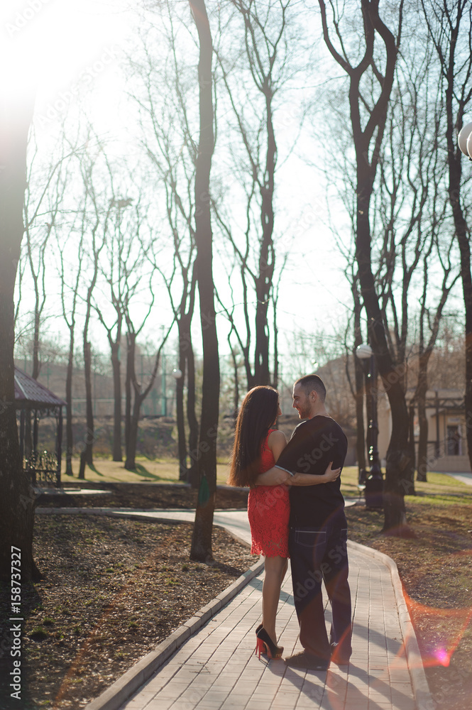 Young beautiful couple in love posing outdoor in city. Young woman smiling with her handsome man