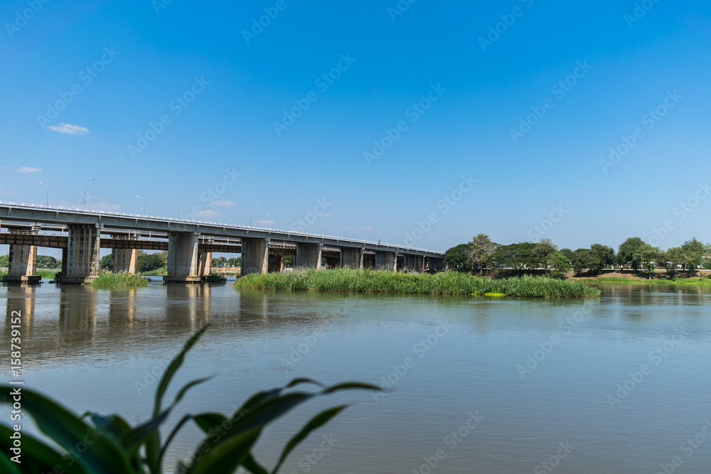 Bridge and river on a bright blue sky