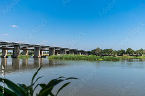 Bridge and river on a bright blue sky © robbiebenz