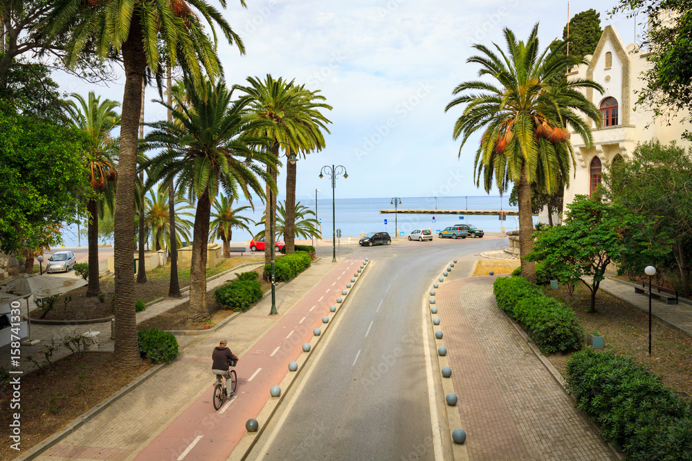 Bikers on bicycle path in Kos town in Greece.