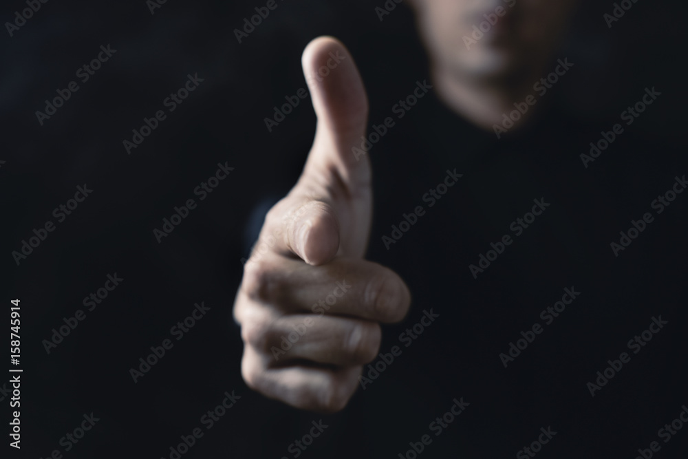 man pointing his finger as a gun