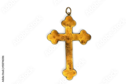 Ancient golden Christian cross isolated on white